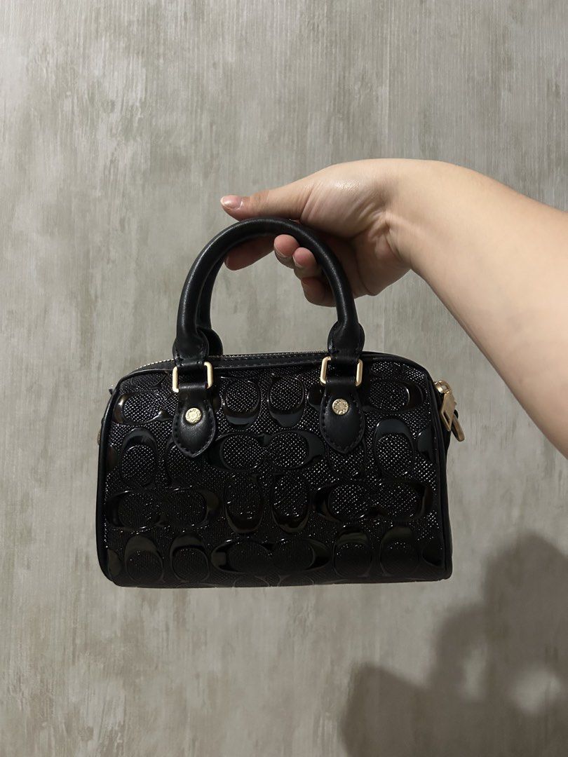 Coach Black Patent Monogram Mini Barrel Bag (Category: Cross-body Bags) located in Caloocan City. Submitted by coolwhale-76ba (Listing ID 1459388915, Image 2). Description: - Cute black Coach mini barrel bag - Shiny patent leather with signature monogram pattern - Gold hardware details - Top handle - Detachable strap -N.g.a - Great for carrying essentials - Perfect size for a night out or casual use.