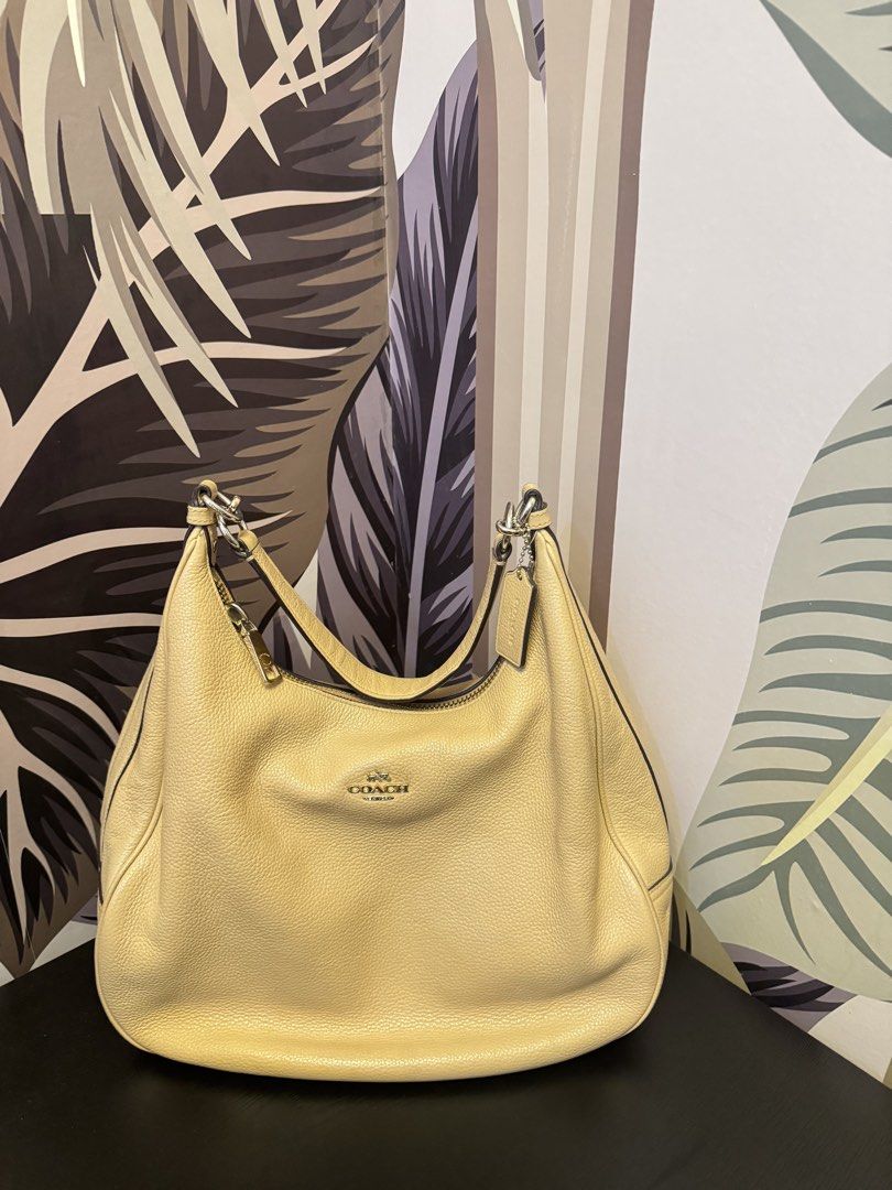 Coach Pebble Leather Hobo Shoulder Bag (Category: Luxury Bags & Wallets) located in Manila. Submitted by abieebey (Listing ID 1459401514, Image 1). Description: - Light yellow Coach hobo bag - Made from durable pebble leather - Features elegant silver hardware - Secure zipper closure - Spacious interior for all your essentials - Comes with the iconic Coach hangtag - Ideal for everyday wear.