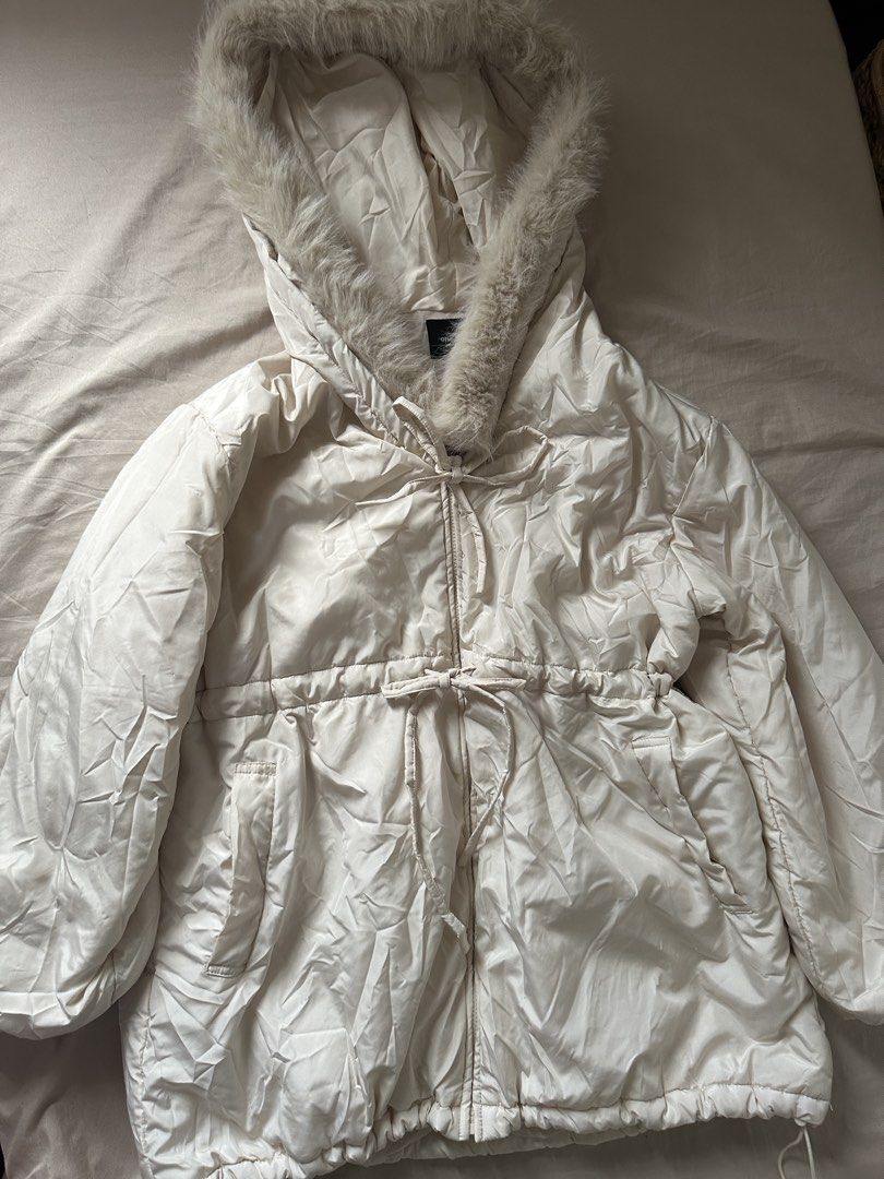 Cream Puffer Jacket with Fur Hood (Category: Coats, Jackets and Outerwear) located in Lipa City. Submitted by chiechums (Listing ID 1459340118, Image 2). Description: - Cream colored puffer jacket from One Way - Drawstring waist and hem for adjustable fit - Hood with soft faux fur trim - Zipper closure with button detail - Perfect for staying warm and stylish.