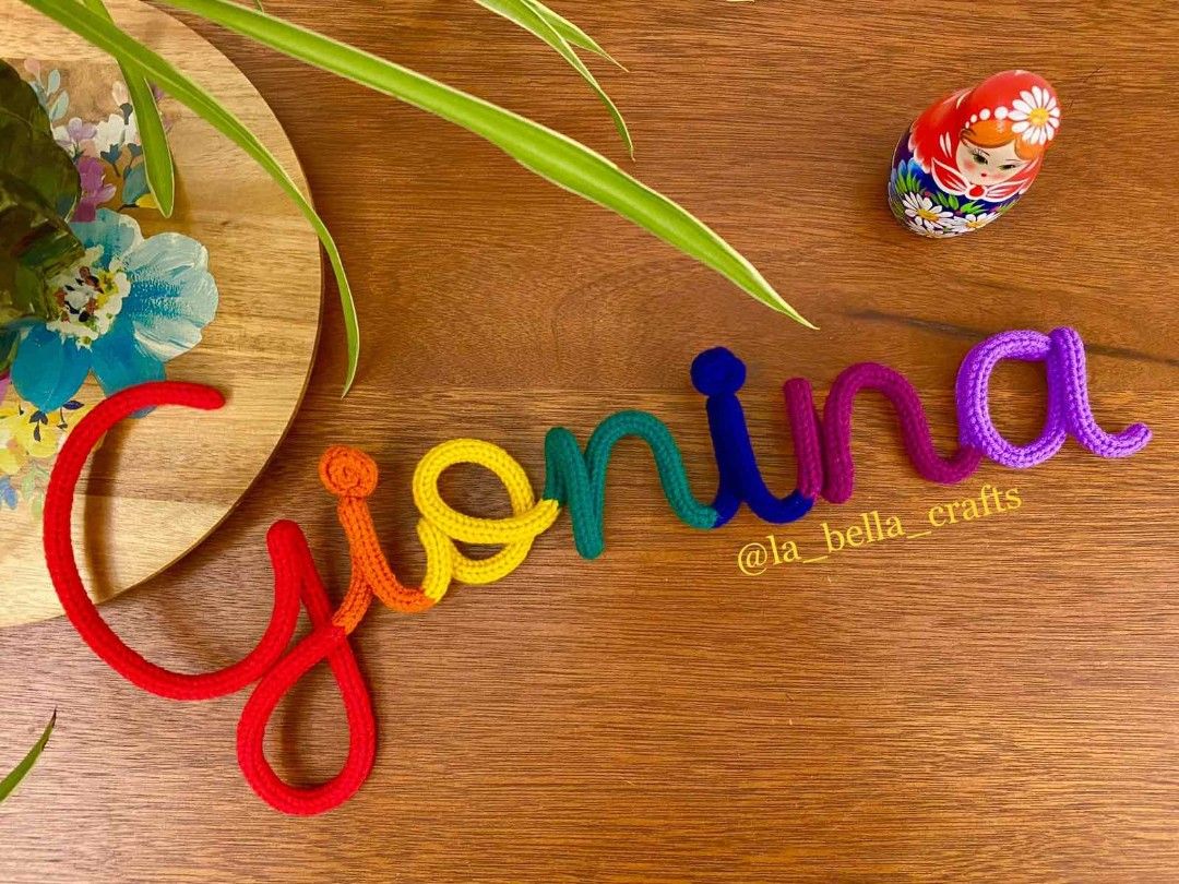 Custom Crocheted Name Sign Wall Art (Category: Handmade Craft) located in Mandaue City. Submitted by zenstone.1367ac (Listing ID 1459371226, Image 2). Description: - Handmade crocheted name signs - Perfect for nursery decor or personalized gifts - Available in various colors - Custom names welcome - Each letter is carefully crafted - Adds a unique touch to any room - Message for custom orders and pricing.