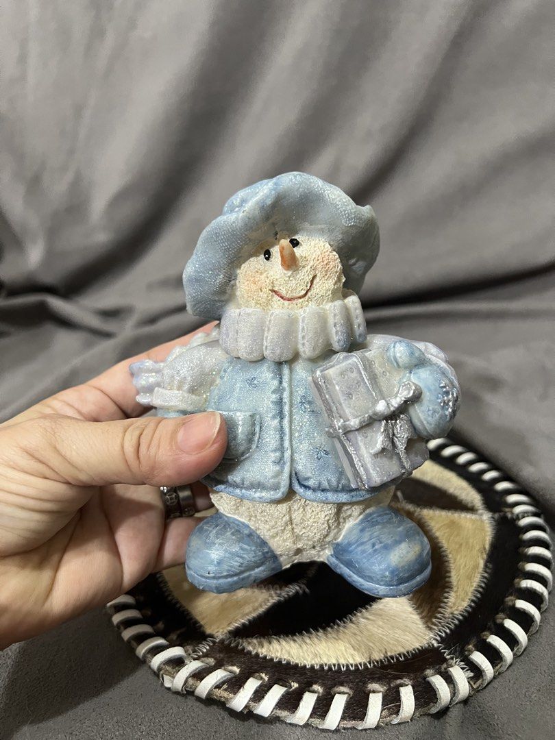 Cute Blue Snowman Figurine with Gift (Category: Other Home Decor) located in Las Pinas. Submitted by maple0305 (Listing ID 1459425443, Image 2). Description: - Adorable blue snowman figurine - Dressed in a hat, coat, and scarf - Holding a small gift box - Measures approximately 5 inches tall - Ideal for holiday and winter decor - Adds a festive touch to shelves and tables.