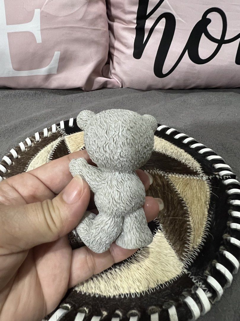 Cute Grey Teddy Bear Figurine on Decorative Mat (Category: Plushies & Soft Toys) located in Las Pinas. Submitted by maple0305 (Listing ID 1459464277, Image 3). Description: - Adorable grey bear figurine - Stands on a unique round mat - Mat features a patchwork fur design - Mat has a black and white striped edge - Ideal for shelf or desk decor - Great for collectors - Makes a sweet gift.