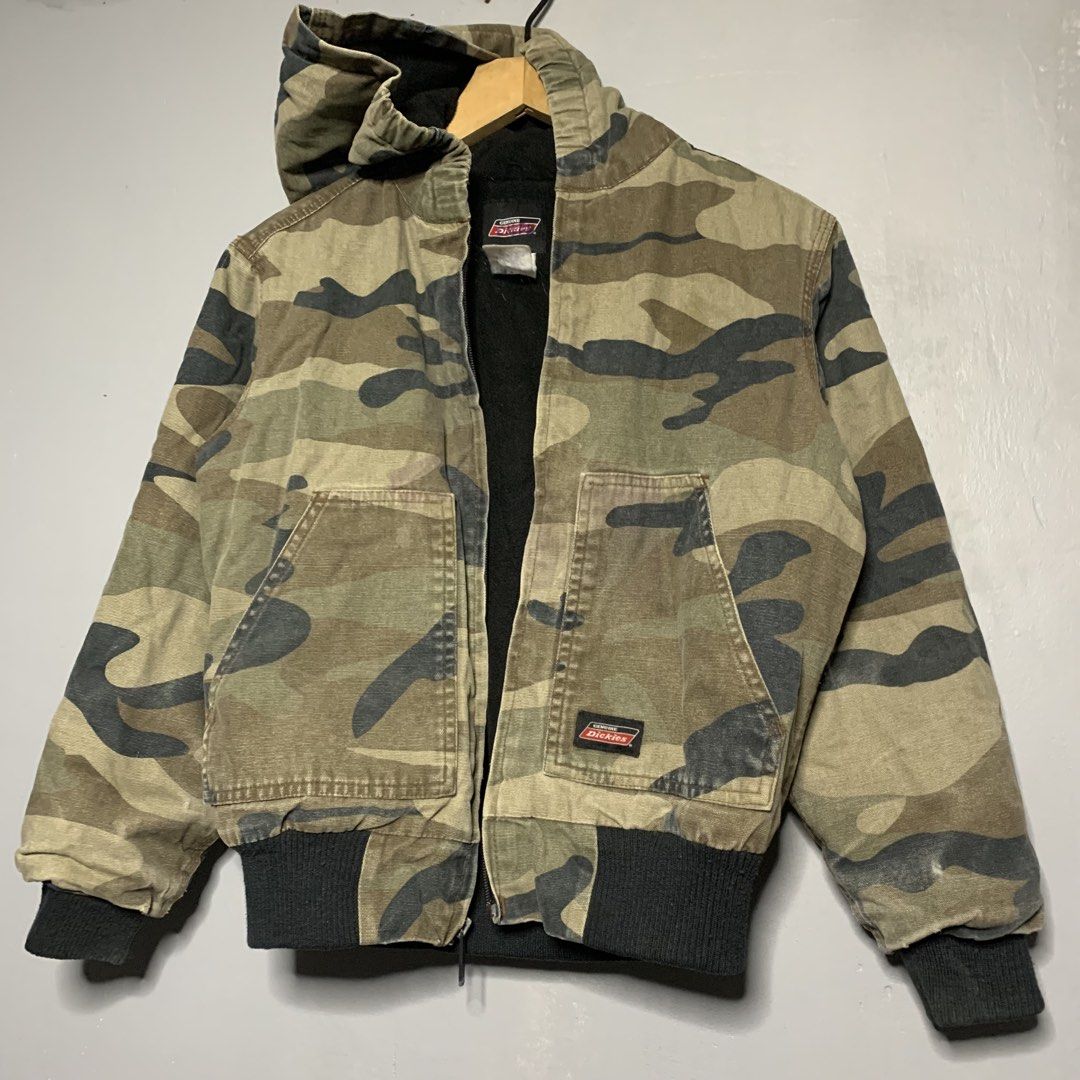 Dickies Camo Hooded Lined Bomber Jacket (Category: Babies & Kids Fashion) located in Manila. Submitted by emplysthrift. (Listing ID 1459374728, Image 2). Description: - Dickies camouflage hooded jacket - Lined with warm black fleece - Ribbed cuffs and hem for a snug fit - Two convenient front pockets - Secure zipper closure - Ideal for cooler weather - Size: Medium (Kids/Kindergarten) Width "18.8 Length "20 Vintage Condition Colorrate: 9/10 Flaws