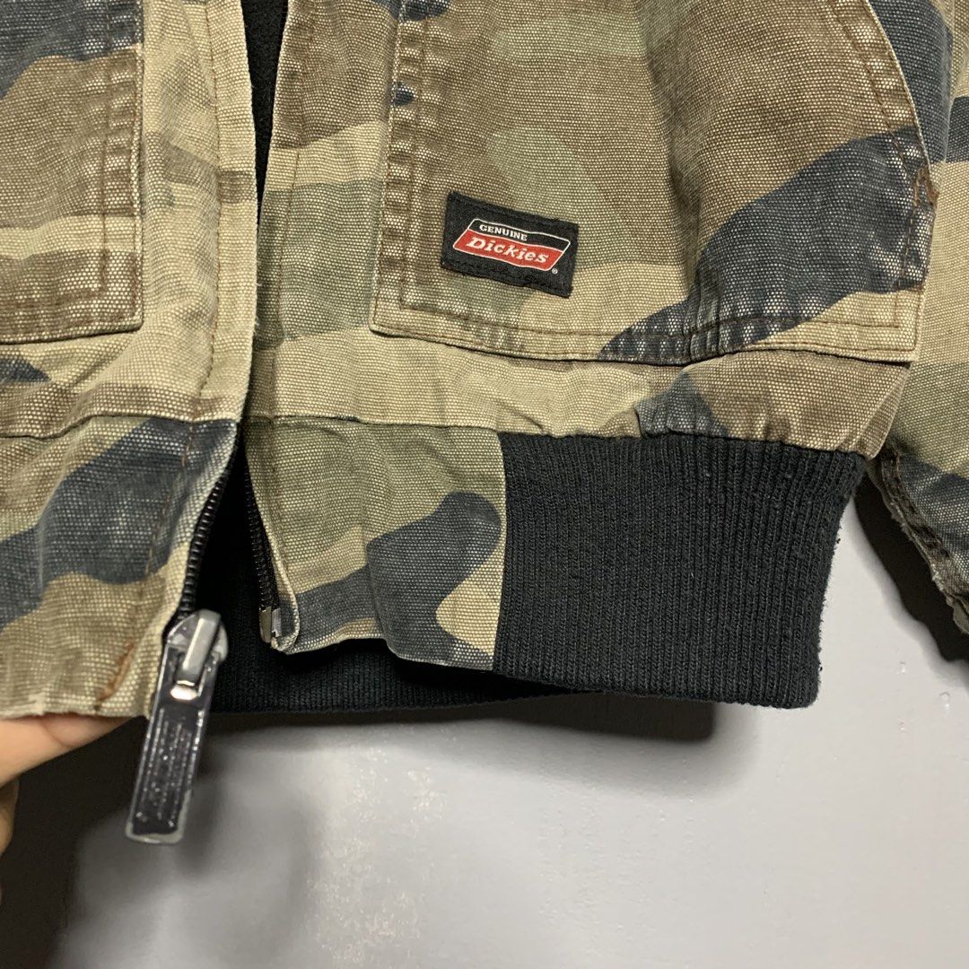 Dickies Camo Hooded Lined Bomber Jacket (Category: Babies & Kids Fashion) located in Manila. Submitted by emplysthrift. (Listing ID 1459374728, Image 3). Description: - Dickies camouflage hooded jacket - Lined with warm black fleece - Ribbed cuffs and hem for a snug fit - Two convenient front pockets - Secure zipper closure - Ideal for cooler weather - Size: Medium (Kids/Kindergarten) Width "18.8 Length "20 Vintage Condition Colorrate: 9/10 Flaws