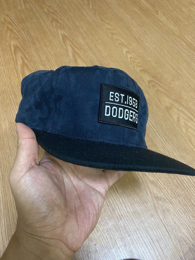 Dodgers Est. 1958 Baseball Cap (Category: Caps & Hats) located in Manila. Submitted by worldwidep31372 (Listing ID 1459301313, Image 2). Description: - Navy blue Los Angeles Dodgers cap - Features 'Est. 1958 Dodgers' patch on the front - Contrasting black brim - Adjustable strap for a custom fit - Official MLB merchandise - Perfect for any Dodgers fan!.