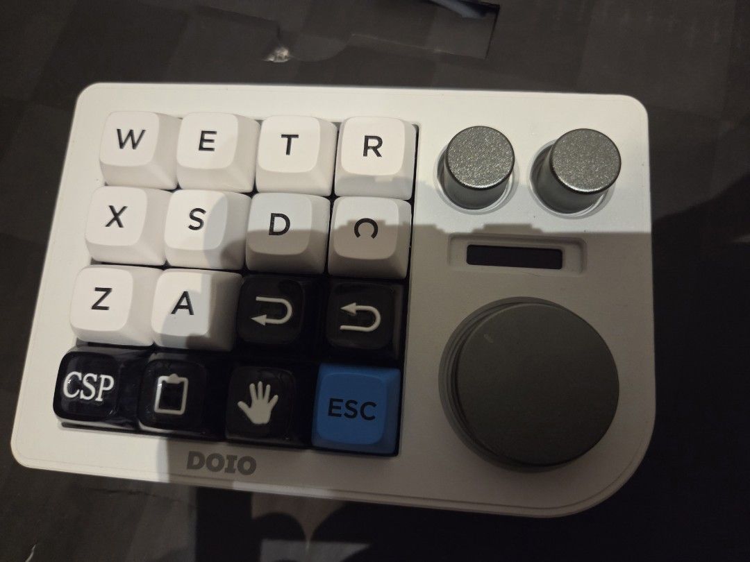 DOIO Programmable Macro Pad with Knobs drawing numpad (Category: Computer Keyboard) located in Klang. Submitted by chupachup021 (Listing ID 1459416624, Image 1). Description: - DOIO Programmable Macro Pad - QWERTY Layout - Custom Keys: CSP, Clipboard Icon, Hand Icon - Includes 2 Small Knobs - Features 1 Large Rotary Encoder - Ideal for Gaming & Productivity Shortcuts - Fully Customizable Functions.