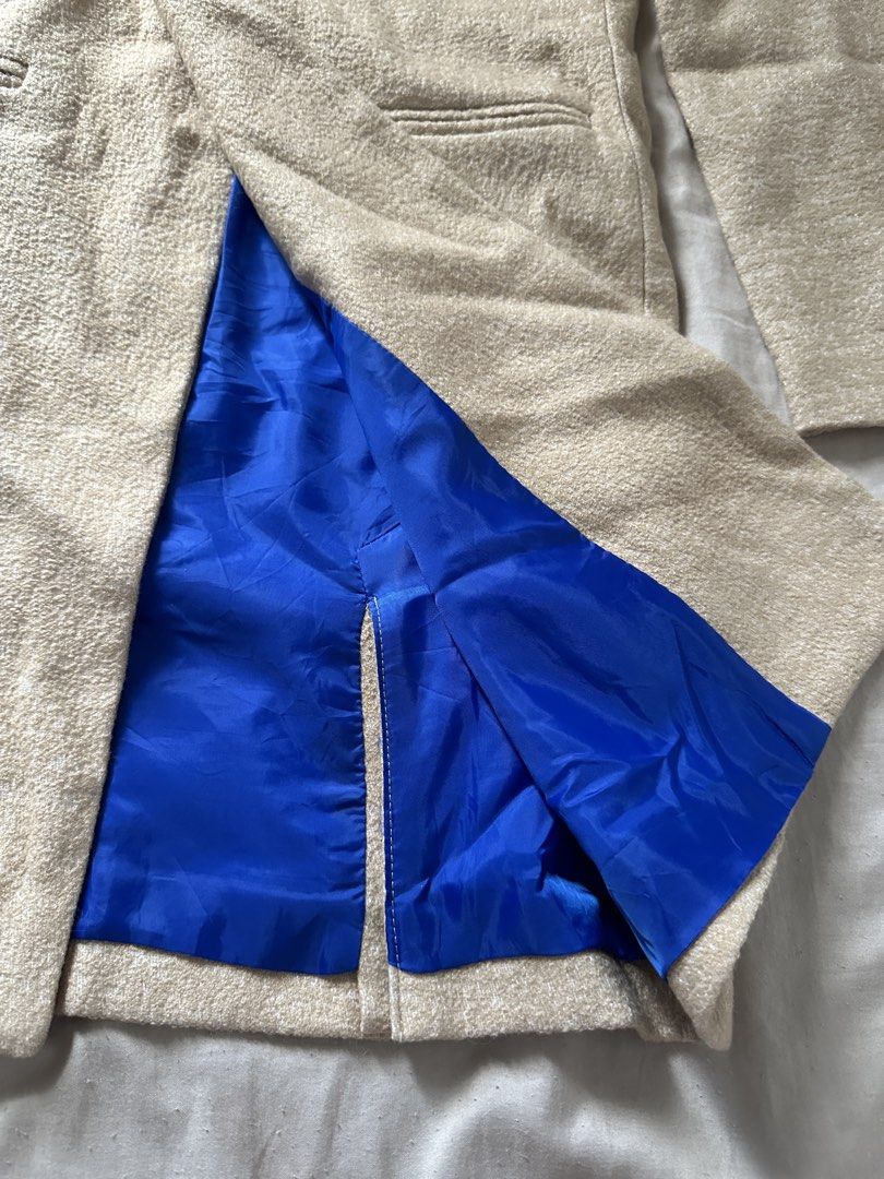 Double-breasted Beige Textured Coat with Blue Lining (Category: Coats, Jackets and Outerwear) located in Lipa City. Submitted by chiechums (Listing ID 1459331198, Image 2). Description: - Beige double-breasted coat - Textured fabric for a sophisticated look - Bright blue lining for a pop of color - Two front pockets for convenience - Back tab with button detail - Front button closure - Ideal for stylish layering.