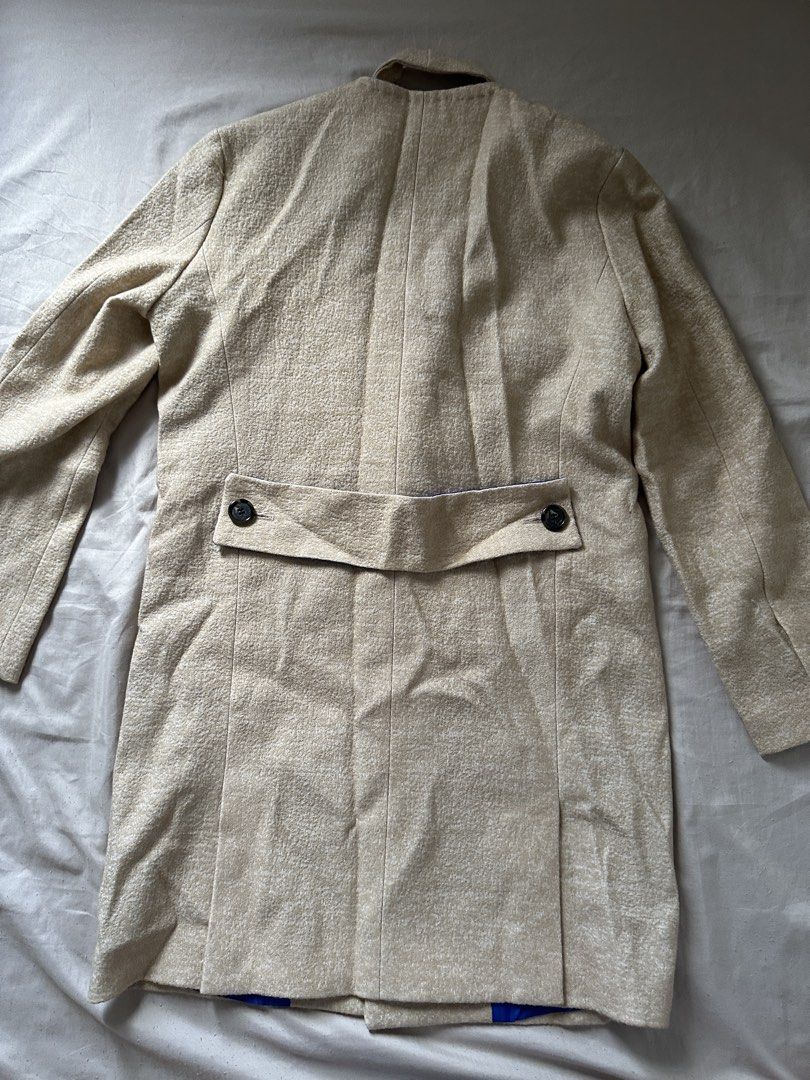Double-breasted Beige Textured Coat with Blue Lining (Category: Coats, Jackets and Outerwear) located in Lipa City. Submitted by chiechums (Listing ID 1459331198, Image 3). Description: - Beige double-breasted coat - Textured fabric for a sophisticated look - Bright blue lining for a pop of color - Two front pockets for convenience - Back tab with button detail - Front button closure - Ideal for stylish layering.