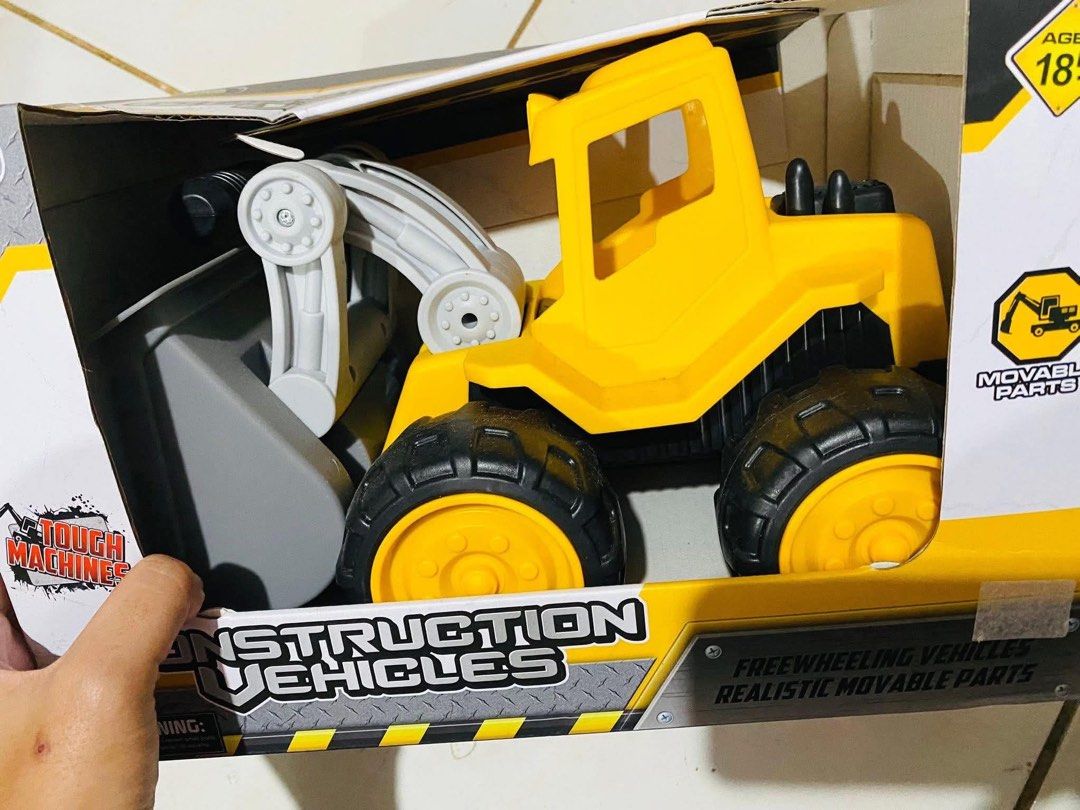 Dream Machine Free Wheeling Construction Vehicle Toy (Category: Kids Toys) located in Cagayan de Oro. Submitted by sethmarko27 (Listing ID 1459433495, Image 2). Description: - Yellow front loader toy - Part of the Dream Machine series - Features free-wheeling action - Movable parts for interactive play - Ideal for little builders - Recommended for ages 3 and up - Tough Machines branding.