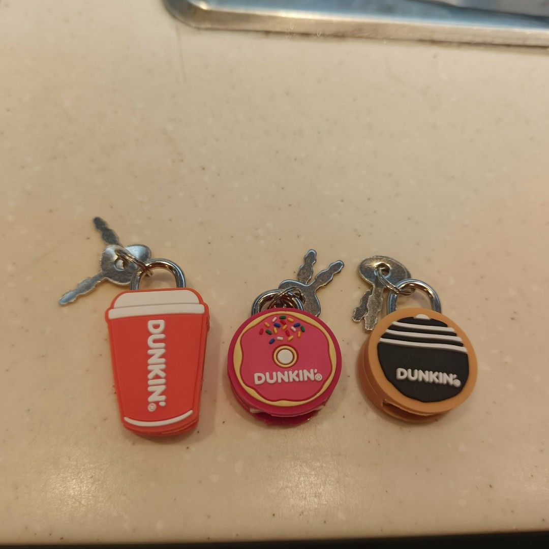 Dunkin' Donuts Lock Charm (Category: Character Goods) located in Taguig. Submitted by decerie09 (Listing ID 1459480277, Image 2). Description: 100pesos each Location : Taguig - Set of 3 cute mini padlocks - Dunkin' Donuts themed designs: coffee cup, donut, and classic orange/black circle logo - Each padlock includes its own key - Ideal for securing diaries, small luggage, or as a fun collectible - Perfect gift for any Dunkin' Donuts enthusiast.