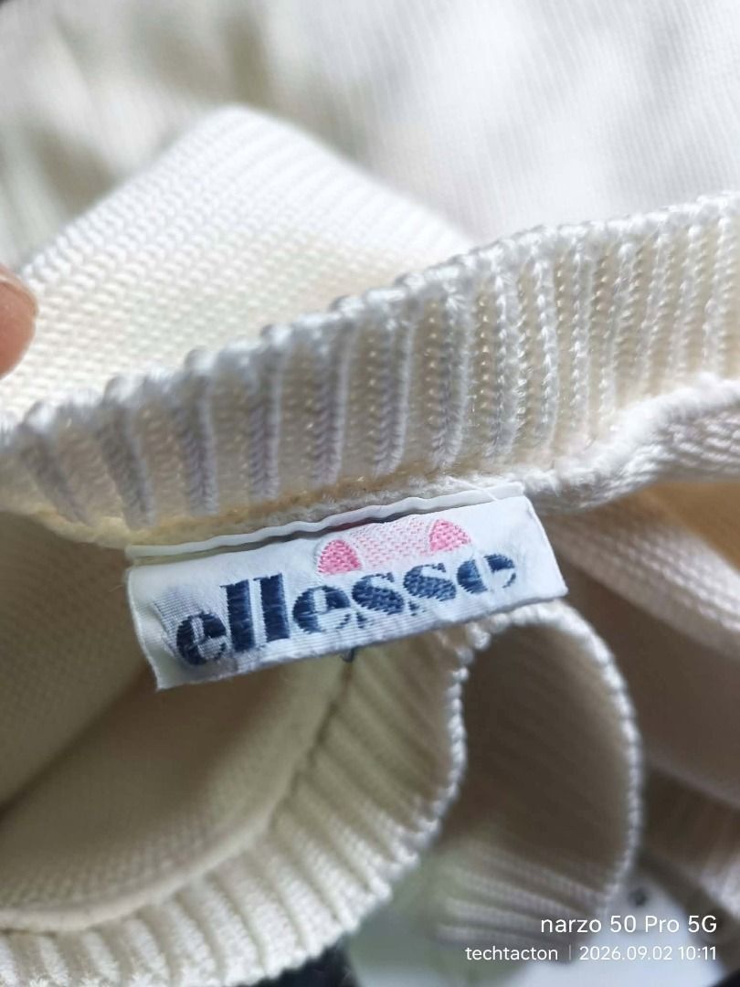Ellesse White Knit Sweater (Category: Coats, Jackets and Outerwear) located in Santo Tomas. Submitted by pickers_corner (Listing ID 1459308205, Image 3). Description: vintage ELLESE knitted Sweater size JASPO L dime 20x24 Very good condition no holes no stain - Brand: Ellesse - Color: White - Style: Knit sweater - Features: Classic Ellesse logo patch on chest - Comfort: Comfortable and casual - Occasion: Great for everyday wear.