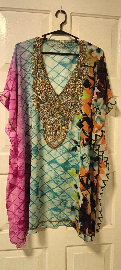 Embellished Kaftan Top (Category: Others Tops) located in Paranaque City. Submitted by yesyesyo (Listing ID 1459378491, Image 2). Description: - Colorful kaftan top with blue and green tie-dye pattern. - Contrasting pink and floral print side panels. - Intricate gold beadwork and sequins embellish the neckline. - Loose, flowy fit for ultimate comfort. - Ideal for beach outings or casual everyday wear. this is not thrifted. all are for personal de