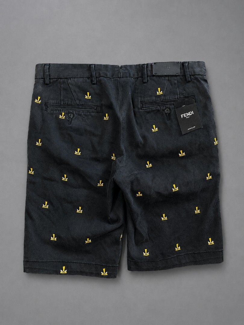 Fendi Black Embroidered Logo Shorts (Category: Shorts) located in Panabo. Submitted by thriftndash (Listing ID 1459312121, Image 2). Description: - Authentic Fendi shorts in classic black. - Features a distinctive all-over yellow embroidered Fendi logo pattern. - Secure button and zip closure at the front. - Two functional pockets at the back. - Expertly crafted in Italy. - Ideal for adding a touch of luxury to your casual outfits..