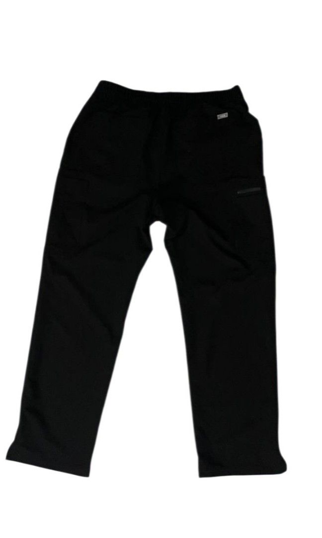FIGS Technical Scrub Pants, (Category: Activewear) located in Manila. Submitted by biniyayaan (Listing ID 1459307642, Image 2). Description: Adjustable Waistband: Features a relaxed elastic waist coupled with a contrasting white external drawstring for a secure fit. Storage & Utility Pockets: Equipped with functional slant pockets at the waist and a prominent zippered security pocket along the side leg. Straight-Leg Cut: Designed with a classic, 