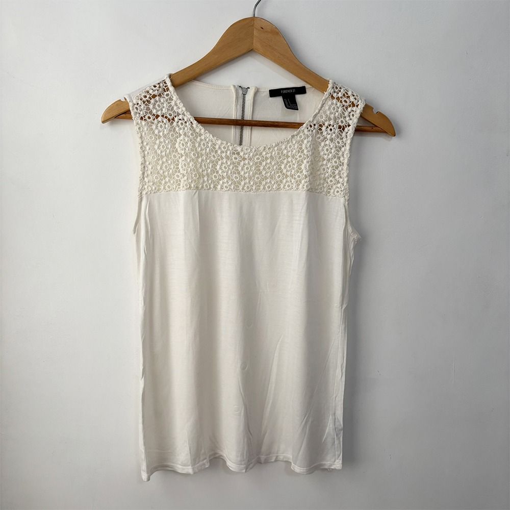 Forever 21 Sleeveless Lace Blouse (Category: Sleeveless) located in San Fernando. Submitted by lilasboutique (Listing ID 1459337578, Image 1). Description: Size: SMALL (S) Chest: 32 in | Length: 23 in Fit: Regular Details: • PRELOVED. Great Condition • Brand: Forever 21 • Color: Cream White.