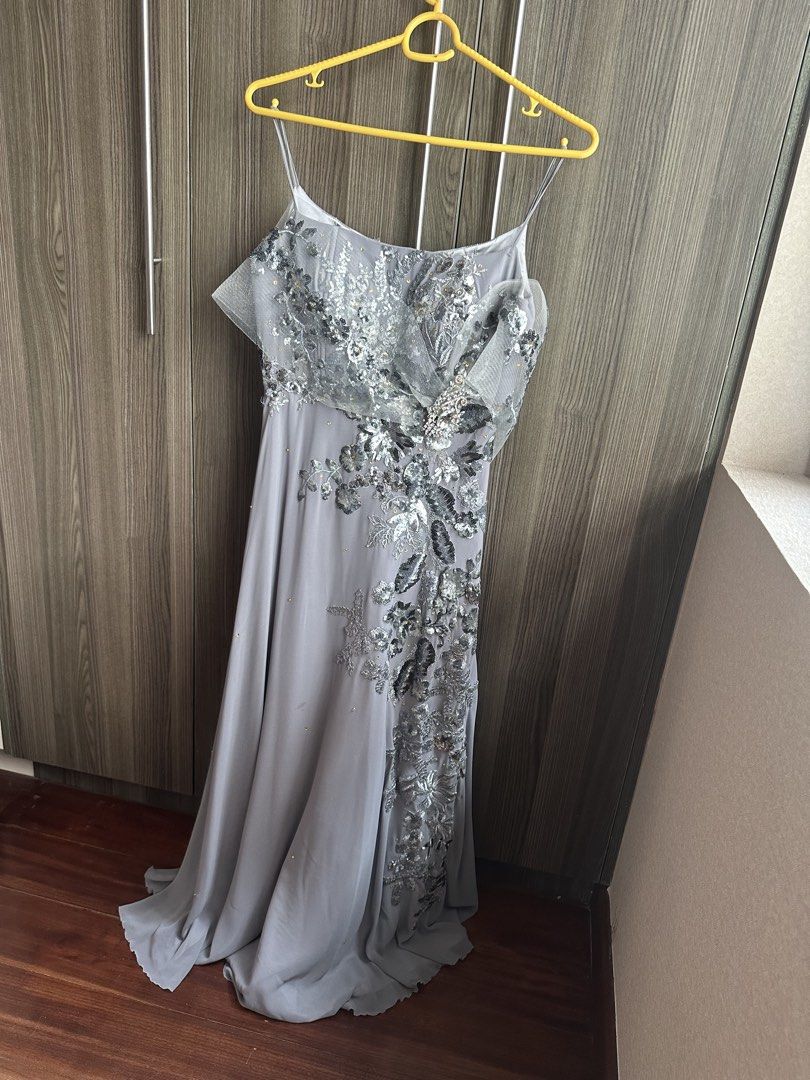 Grey Embellished Evening Gown with Spaghetti Straps (Category: Evening dresses & gowns) located in Alicia. Submitted by muffinberry821 (Listing ID 1459348775, Image 1). Description: - Stunning grey evening gown - Intricate silver embellishments on bodice and skirt - Delicate spaghetti straps - Flowing hemline - Unique sheer overlay on bodice - Ideal for formal events and parties - Beautiful drape and fit.