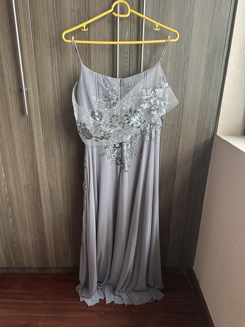 Grey Embellished Evening Gown with Spaghetti Straps (Category: Evening dresses & gowns) located in Alicia. Submitted by muffinberry821 (Listing ID 1459348775, Image 2). Description: - Stunning grey evening gown - Intricate silver embellishments on bodice and skirt - Delicate spaghetti straps - Flowing hemline - Unique sheer overlay on bodice - Ideal for formal events and parties - Beautiful drape and fit.