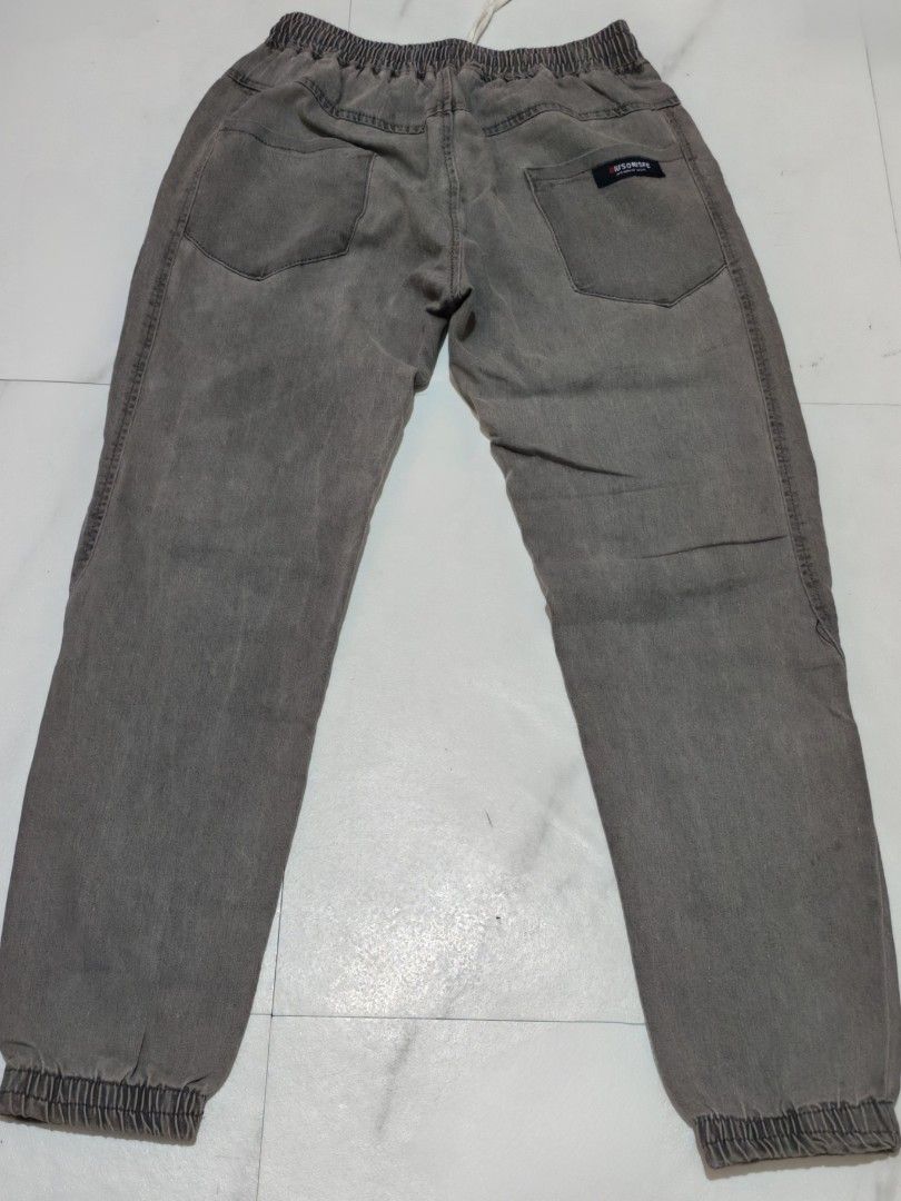 Grey Jogger Pants (Category: Other Bottoms) located in Taguig. Submitted by apzdeclutter (Listing ID 1459393588, Image 3). Description: - Grey jogger pants - Elastic waistband with drawstring - Cuffed ankles - Two side pockets and two back pockets - Washed denim-like material - Comfortable for everyday wear - Ideal for casual outfits.