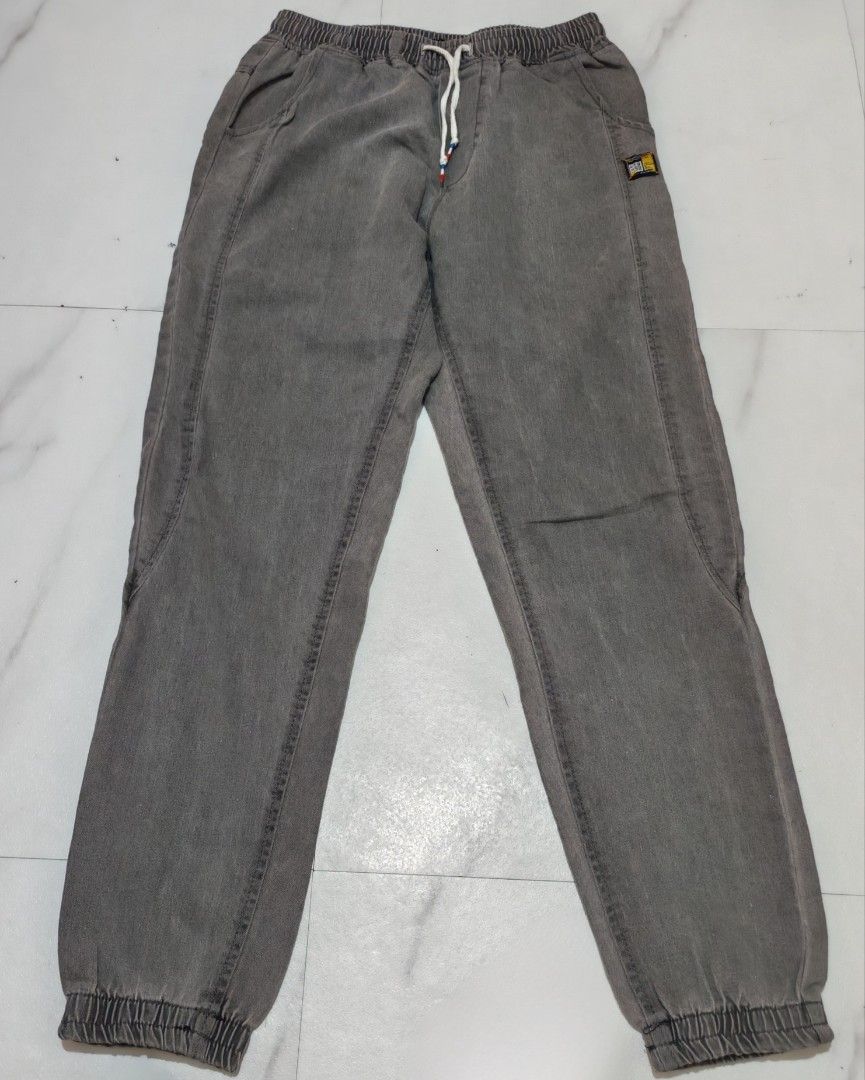 Grey Jogger Pants (Category: Other Bottoms) located in Taguig. Submitted by apzdeclutter (Listing ID 1459393588, Image 2). Description: - Grey jogger pants - Elastic waistband with drawstring - Cuffed ankles - Two side pockets and two back pockets - Washed denim-like material - Comfortable for everyday wear - Ideal for casual outfits.