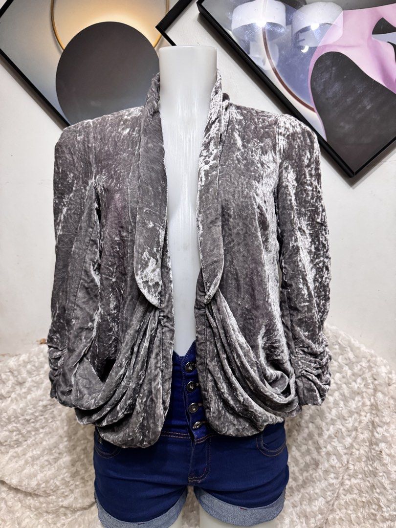 Grey shiny Velvet Drape Front Jacket (Category: Coats, Jackets and Outerwear) located in Marikina City. Submitted by lorradel (Listing ID 1459426312, Image 1). Description: - Grey velvet jacket - Draped front design - Ruched sleeves for a unique touch - Versatile: pairs well with jeans or can be dressed up - Perfect for nights out or stylish daytime wear - Features unique texture and design - MAY HAVE some washable stains (hindi maiiwasan) needs 