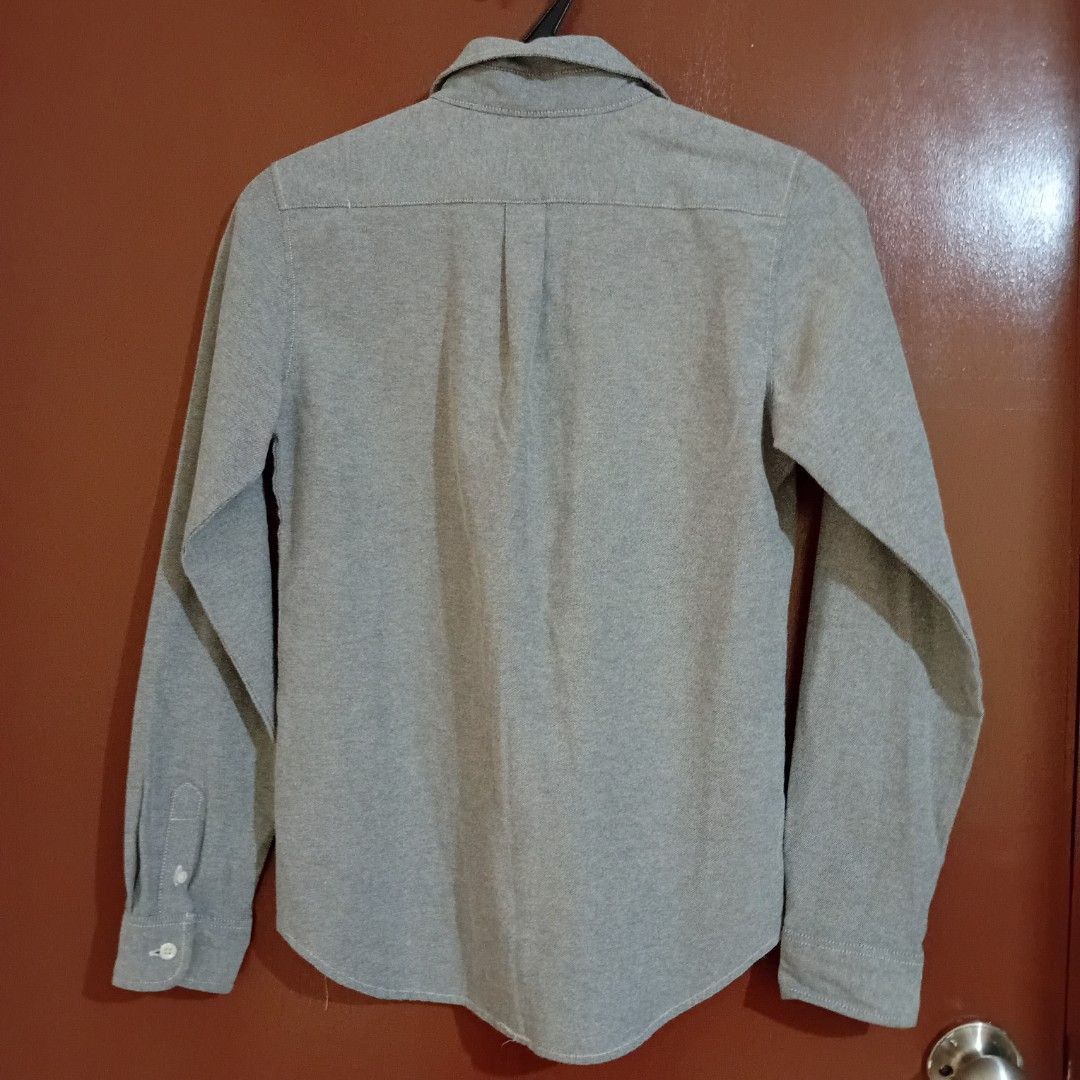 Grey Women's Polo (Medium) (Category: Longsleeves) located in Silang. Submitted by trish125 (Listing ID 1459305207, Image 2). Description: Sakto fit sakin I'm 5'0 and 29 waistline w/ slight allowance in length (see last pic) - Brand: DEBA&CO - Color: Grey - Style: Long-sleeved button-up shirt - Features: Single chest pocket, button front closure, button cuffs - Size: M - Occasion: Casual wear.