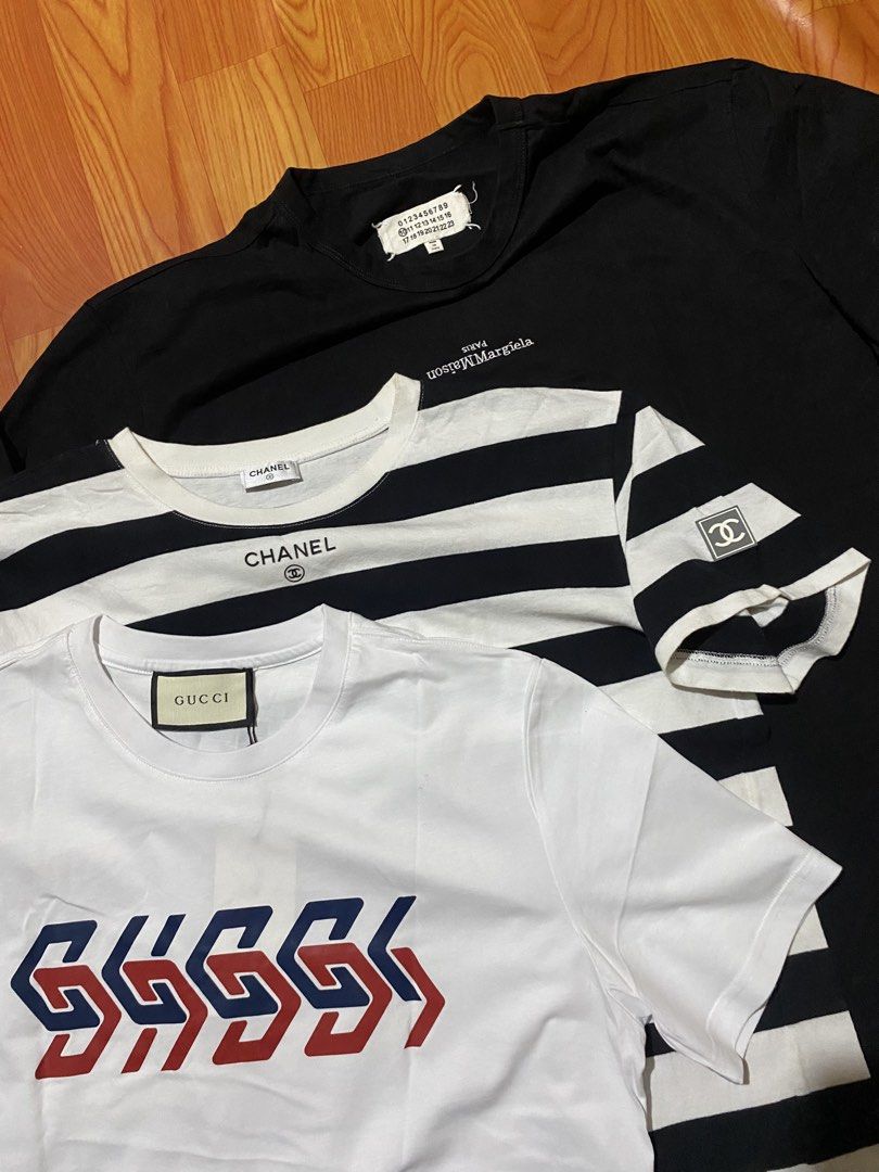 Gucci, Chanel, Maison Margiela T-Shirts Bundle (Category: Luxury Apparel) located in Cebu City. Submitted by monflor (Listing ID 1459432383, Image 3). Description: - Bundle of 3 designer t-shirts - Includes: White Gucci tee (red/blue logo), Black & White striped Chanel tee, Black Maison Margiela tee (small white text) - All shirts are size L - Perfect additions to your wardrobe Good condition No issues Price each 875.