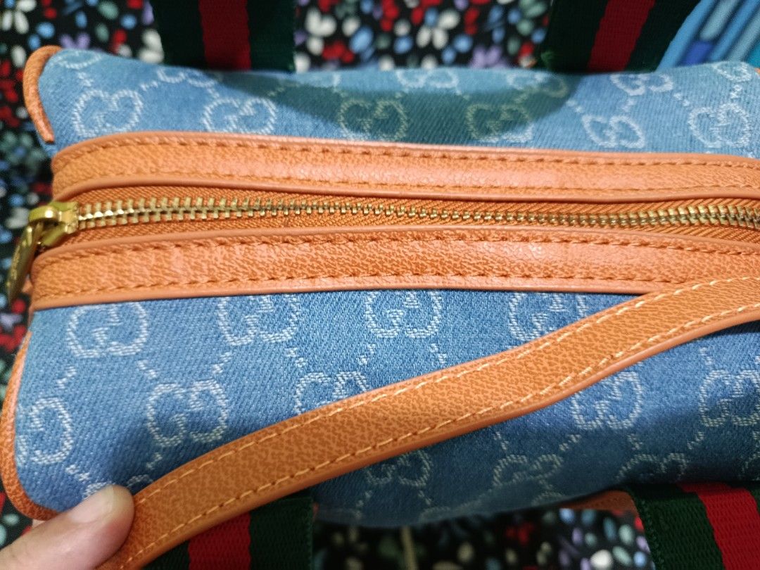 Gucci Denim Monogram Mini Boston Bag (Category: Luxury Bags & Wallets) located in Bacoor. Submitted by myte09 (Listing ID 1459486862, Image 2). Description: - Gucci mini Boston bag - Classic GG monogram pattern on denim - Top handles and detachable shoulder strap - Signature green and red stripe detail - Gold hardware - Comes with original Gucci box.