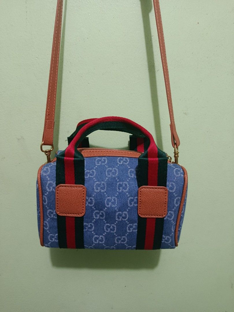 Gucci Denim Monogram Mini Boston Bag (Category: Luxury Bags & Wallets) located in Bacoor. Submitted by myte09 (Listing ID 1459486862, Image 3). Description: - Gucci mini Boston bag - Classic GG monogram pattern on denim - Top handles and detachable shoulder strap - Signature green and red stripe detail - Gold hardware - Comes with original Gucci box.