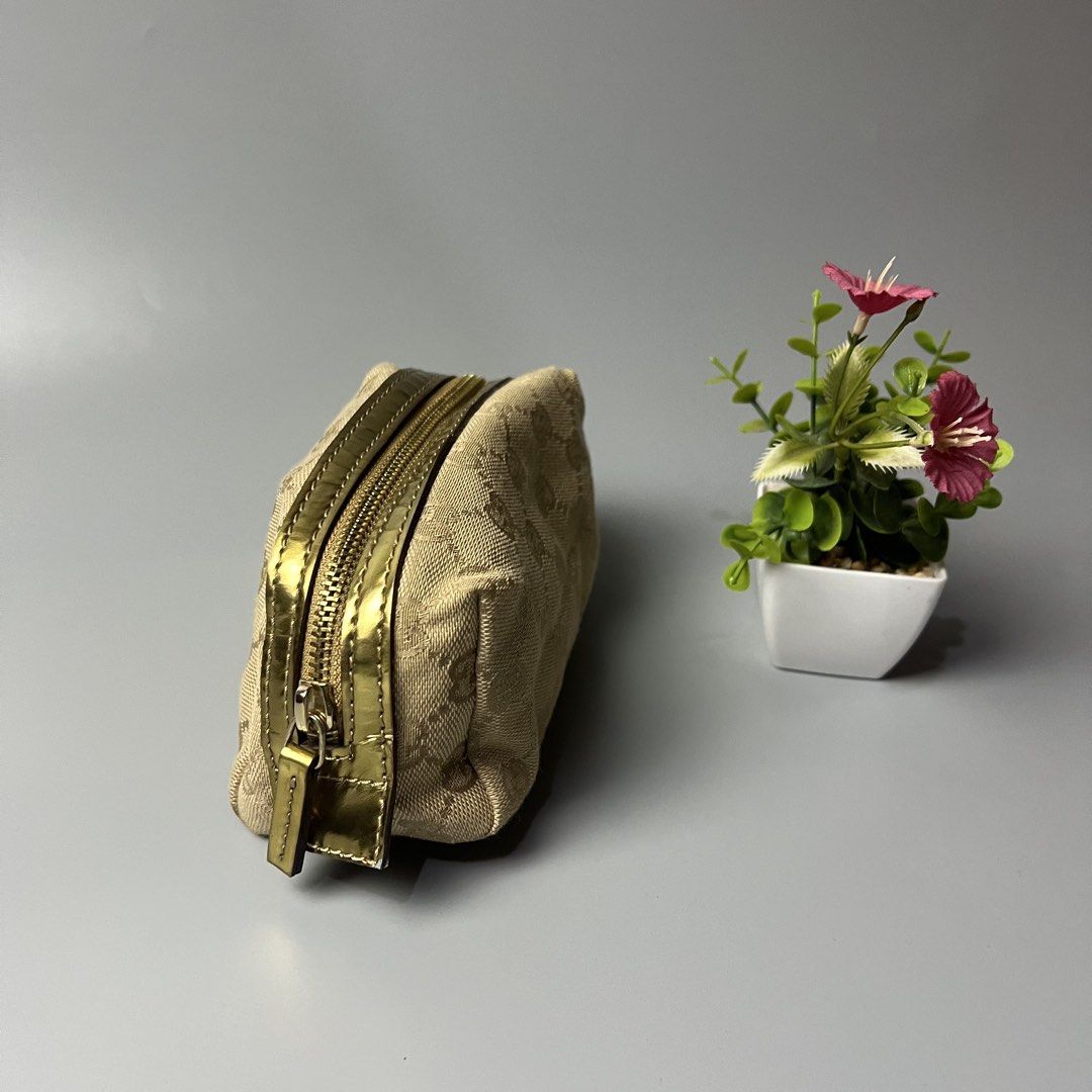 Gucci GG Monogram Pouch Cosmetic Bag (Category: Luxury Bags & Wallets) located in Bago City. Submitted by g___shop (Listing ID 1459391175, Image 2). Description: - Authentic Gucci pouch - Classic GG monogram canvas - Gold zipper detail - Ideal for makeup or small essentials - Compact size, great for travel or daily use - Clean interior - Zipper works smoothly.