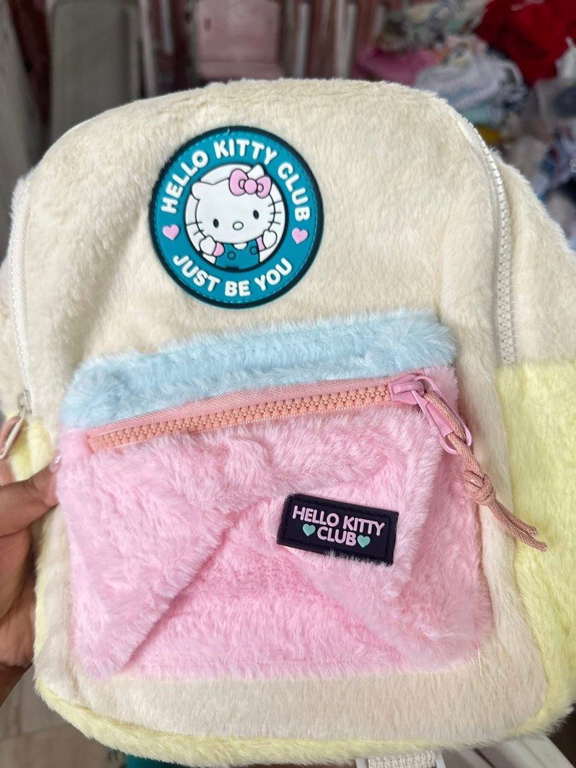 Hello Kitty Club Fluffy Backpack (Category: Backpacks) located in Santa Rosa. Submitted by yasss23 (Listing ID 1459305473, Image 2). Description: - Adorable fluffy backpack with Kitty Club design. - Features a charming color palette: cream, pastel blue, pink, and yellow. - Includes a spacious main compartment for essentials. - Convenient front zippered pocket for easy access. - Adjustable straps for a comfortable fit. - Ideal for kids, students, 