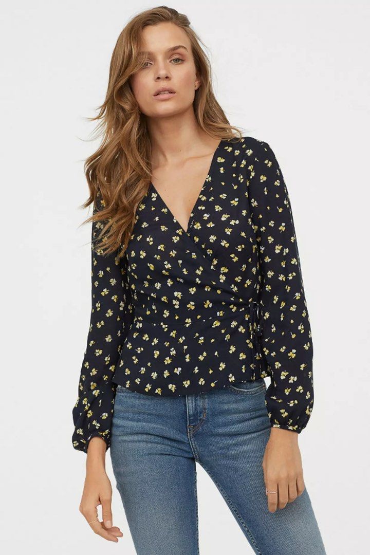 H&M Blue Floral WrapOver Blouse (Category: Blouses) located in Binan City. Submitted by myprelovedhaul (Listing ID 1459405275, Image 2). Description: This is an H&M dark blue floral wrap-style blouse featuring long sleeves, a V-neckline, and small yellow flowers..