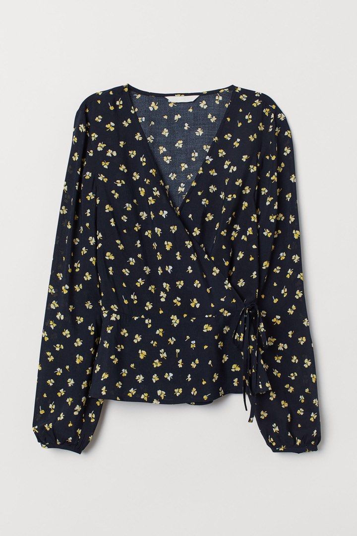 H&M Blue Floral WrapOver Blouse (Category: Blouses) located in Binan City. Submitted by myprelovedhaul (Listing ID 1459405275, Image 1). Description: This is an H&M dark blue floral wrap-style blouse featuring long sleeves, a V-neckline, and small yellow flowers..