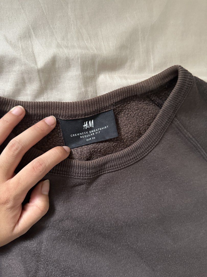H&M Crewneck Sweatshirt Regular Fit - Dark Grey (Category: Coats, Jackets and Outerwear) located in Lipa City. Submitted by chiechums (Listing ID 1459340619, Image 2). Description: - Dark grey H&M crewneck sweatshirt - Size: EUR XS - Fit: Regular - Features: Raglan sleeves, ribbed cuffs and hem - Style: Comfortable and casual, perfect for layering or wearing solo.