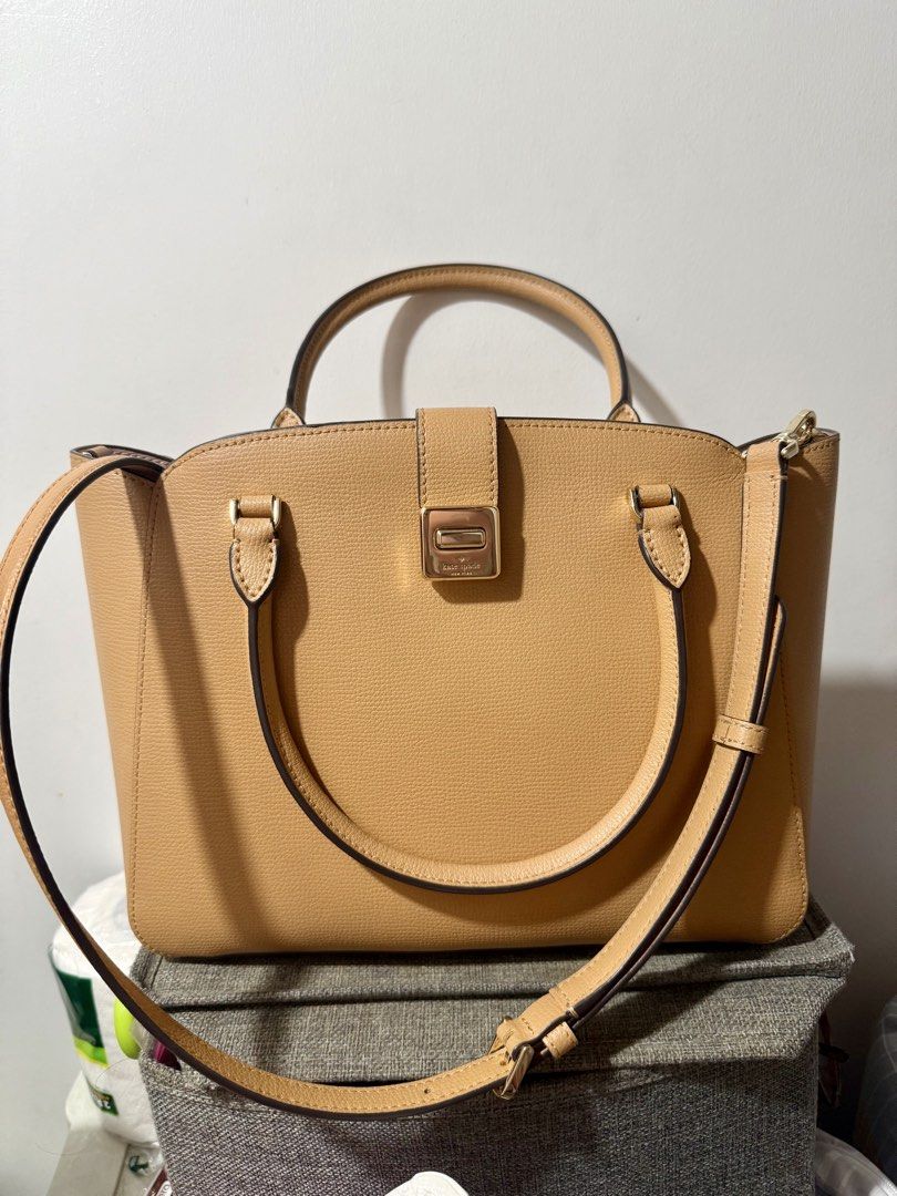 Kate Spade Satchel Bag (Category: Cross-body Bags) located in Manila. Submitted by muggles_closet (Listing ID 1459355699, Image 1). Description: Kate Spade New York Phoebe Satchel in a warm tan refined grain leather, featuring a distinctive metallic turn-lock closure on the front. Measurements 10.67” D Strap Drop: 4.53” Handle Drop: 4.5” Features Strap Drop: 22” Metal Pinmount Logo Closure Type: turn lock closure Exterior: front slip pocket Mater