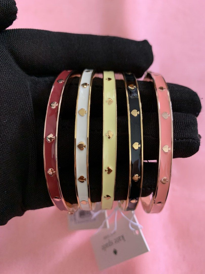 Kate Spade Spade Flower Enamel Bangles Set (Category: Bracelets) located in Batangas. Submitted by thebuyerss (Listing ID 1459301776, Image 1). Description: - Set of 5 Kate Spade bangles - Features the iconic spade flower design - Colors: Red, White, Yellow, Black, Pink - Gold-tone hardware - Brand new with original tags - Versatile for stacking or wearing solo.