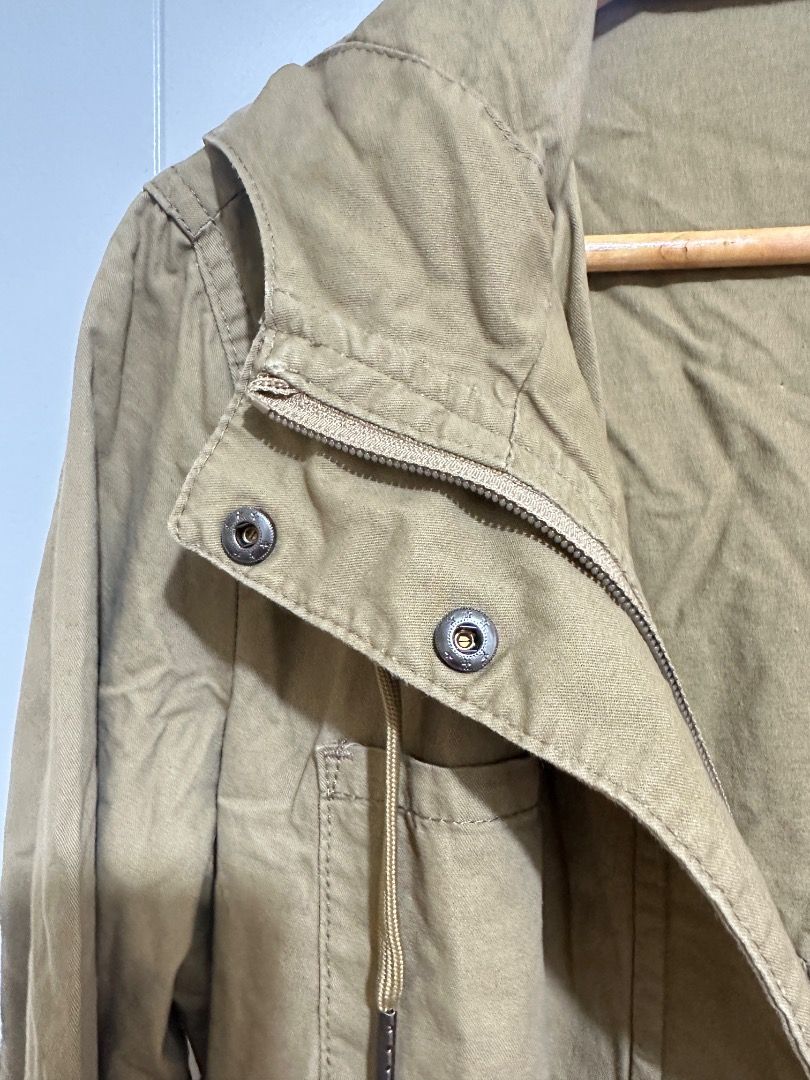 Khaki Utility Jacket Medium (Category: Coats, Jackets and Outerwear) located in Mandaluyong City. Submitted by lovedbyjaaaam (Listing ID 1459301291, Image 3). Description: - Brand: red girl - Color: Khaki - Size: Medium - Closure: Zip and button front - Features: Drawstring waist for adjustable fit, multiple front pockets - Style: Utility jacket, great for layering.
