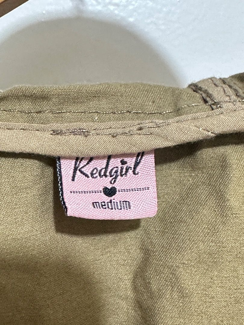 Khaki Utility Jacket Medium (Category: Coats, Jackets and Outerwear) located in Mandaluyong City. Submitted by lovedbyjaaaam (Listing ID 1459301291, Image 2). Description: - Brand: red girl - Color: Khaki - Size: Medium - Closure: Zip and button front - Features: Drawstring waist for adjustable fit, multiple front pockets - Style: Utility jacket, great for layering.