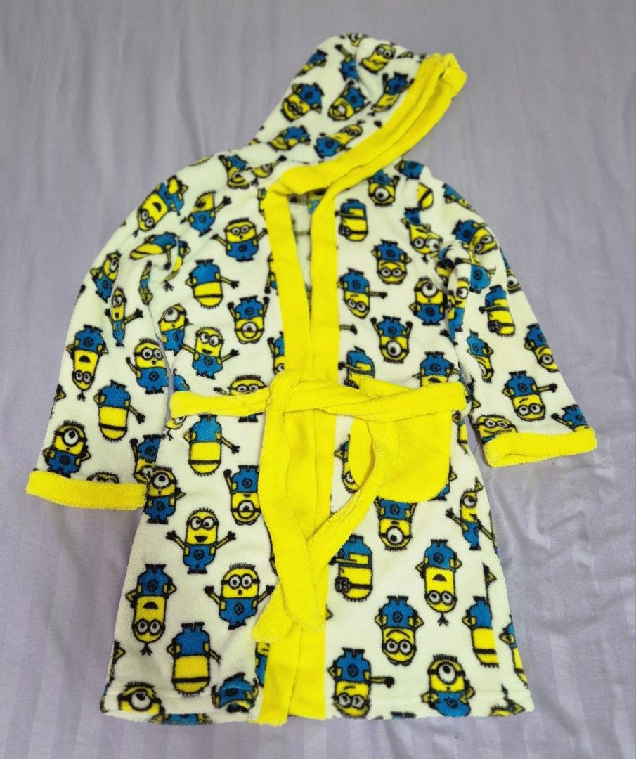 Bath Robe with Hood by Minion (Category: Babies & Kids Fashion) located in Manila. Submitted by sorayabarr50152 (Listing ID 1459371837, Image 1). Description: - Adorable Minion robe for kids - Fun all-over Minion character print - Hooded design for extra warmth - Includes a tie belt for a secure and snug fit - Bright yellow trim and belt for a pop of color - Made from soft and cozy material - Ideal for bath time, pool, or lounging at home.