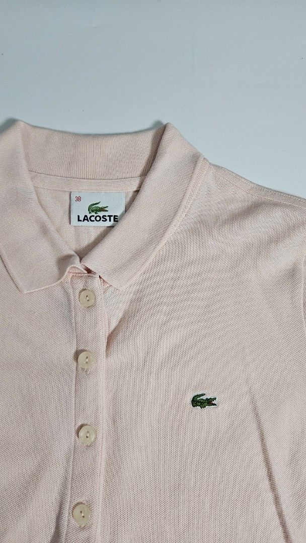 Lacoste polo shirt (Category: Others Tops) located in Alfonso. Submitted by jbcamet (Listing ID 1459334833, Image 2). Description: - Brand: Lacoste - Type: Polo Shirt - Color: Pastel Pink - Size: 38 (EU/UK 10/US 6/Medium) - Features: Embroidered Lacoste crocodile logo, buttoned placket - Material: Likely cotton blend (typical for Lacoste polos, check care tag for specifics) - Condition: Excellent, pre-loved - Style: Classic, versatile, smart casu