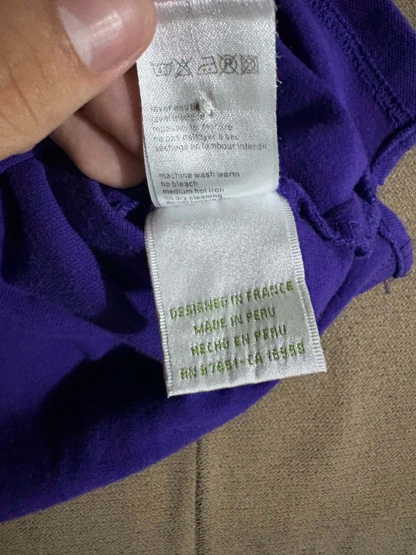Lacoste Purple Polo Shirts (2 pcs) (Category: Tshirts & Polo Shirts ) located in Manila. Submitted by thriftthings824 (Listing ID 1459424344, Image 3). Description: - Two purple Lacoste polo shirts available. - One shirt in a darker shade of purple, the other in a lighter shade. - Both feature the signature Lacoste crocodile logo. - Designed in France, made in Peru. - Ideal for casual wear or a sporty aesthetic. - Please check the photos for deta