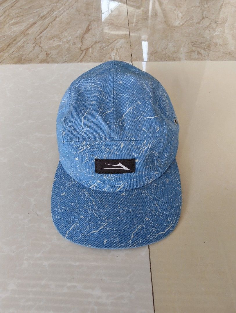 Lakai Limited Footwear 5 Panel Cap Blue White Pattern (Category: Caps & Hats) located in Digos. Submitted by cebor (Listing ID 1459365302, Image 1). Description: -Lakai 5-panel cap - White crackle pattern - Features Lakai logo on the front - Adjustable strap at the back for a comfortable fit - Made from 100% cotton - Designed in the USA -Colorrate:9.2/10 -Issue:minor watermarks.