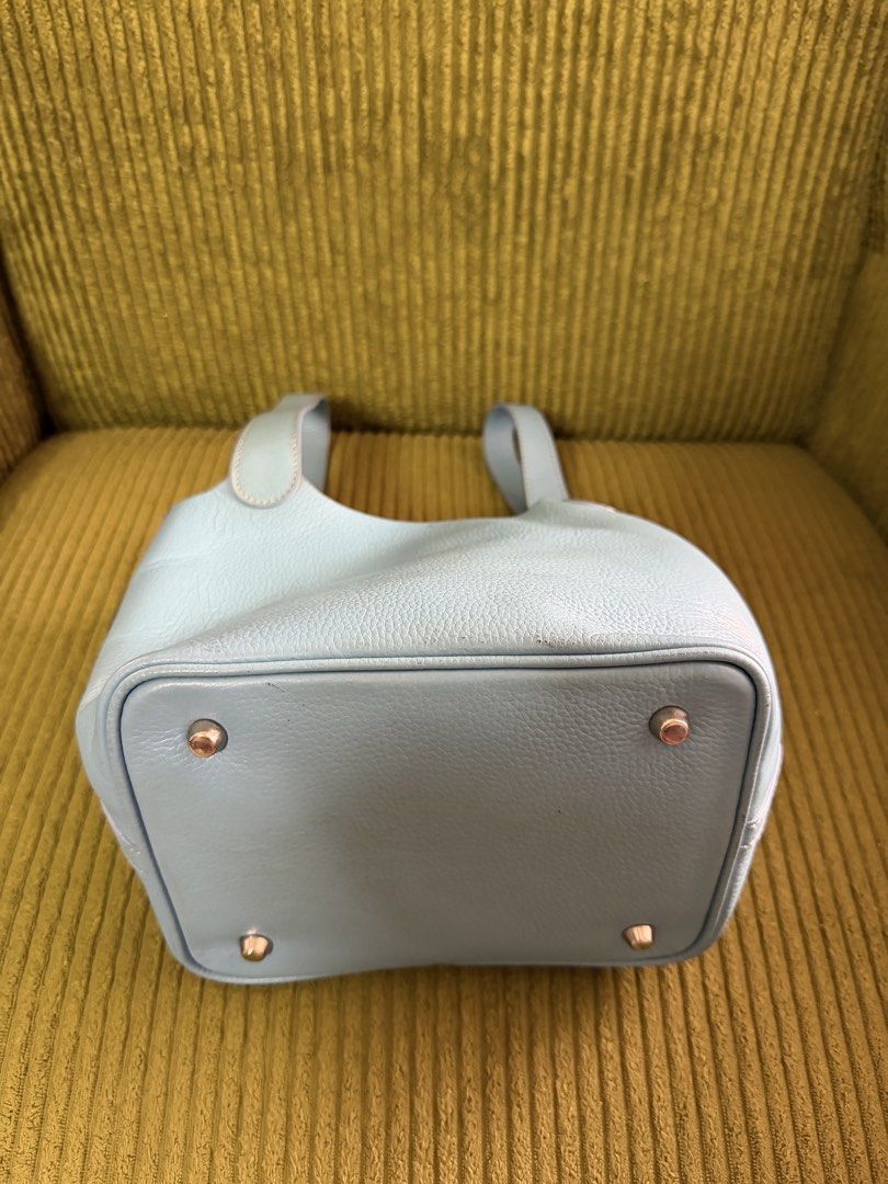 Light Blue Leather Bucket Bag with Top Handles (Category: Clutches) located in Manila. Submitted by lovelystuffmaycomeandgo (Listing ID 1459332997, Image 2). Description: - Cute light blue bucket bag - Color- Powder Blue - Width- 5 in, Length- 8 in, Height- 7 in, - Handle- 6 in dropdown - Textured leather material - Structured base with protective metal feet - Comfortable top handles for easy carrying - Secure strap closure inside - Ideal for eve