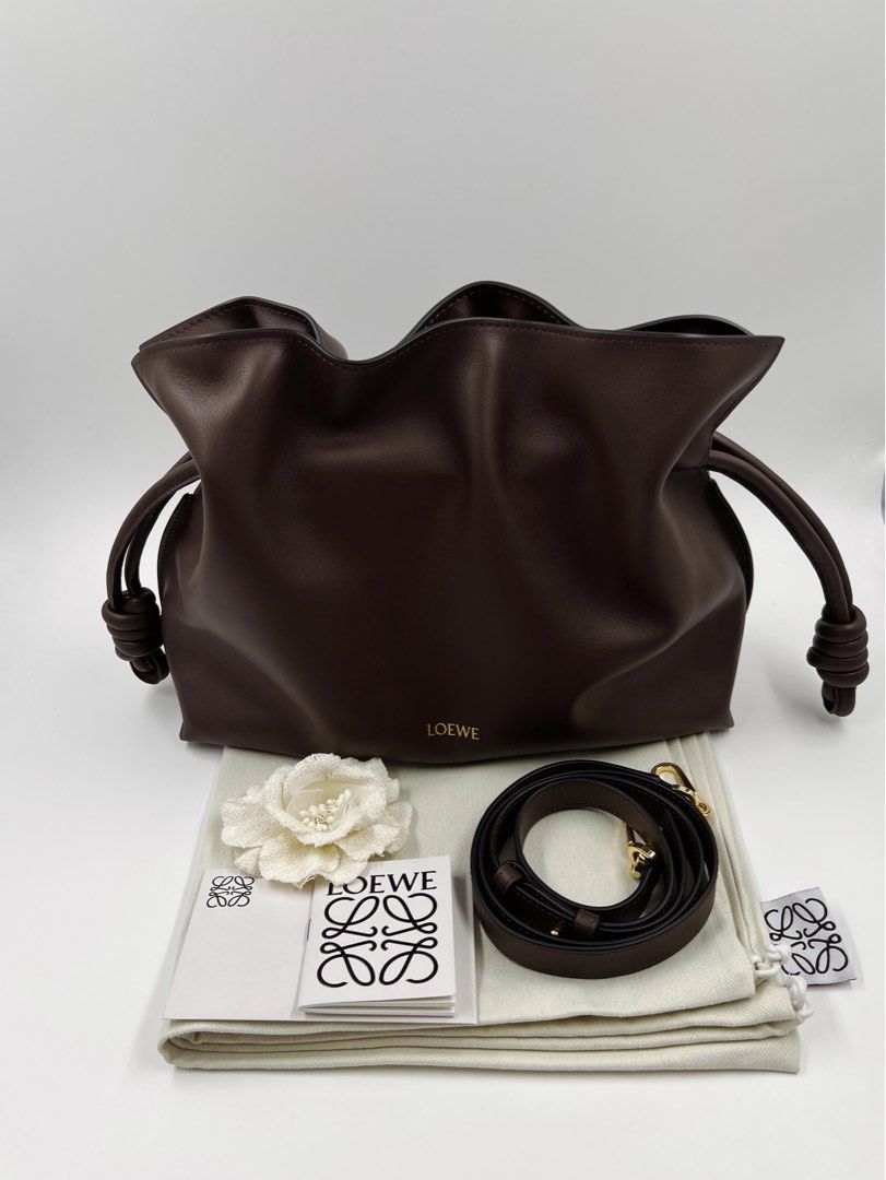 ⚜️Loewe Flamenco Medium Bag (Category: Luxury Bags & Wallets) located in Makati City. Submitted by 90sangel (Listing ID 1459331222, Image 2). Description: •Item: Loewe Flamenco clutch bag 🍂🤎 •Size: Medium 🍂 11.8" x 9.7" •Condition: Excellent! *Very soft and slouchy bag with a cinched closure and knot drawstrings. This medium version is crafted in nappa calfskin.🤎🍂 Can wear Shoulder, crossbody or hand carry Detachable and adjustable strap, we