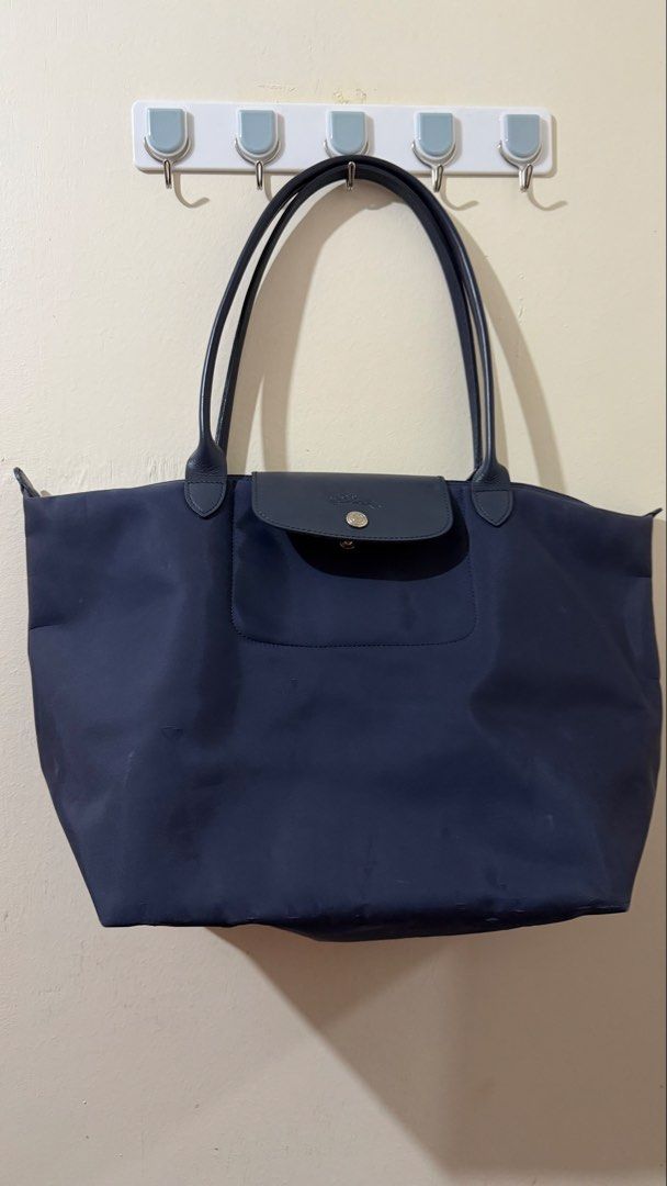 Longchamp Le Pliage Large Tote Bag (Navy Blue) (Category: Luxury Bags & Wallets) located in Rizal. Submitted by lovegclothingph (Listing ID 1459409248, Image 1). Description: - Classic Longchamp tote bag in navy blue. - Made from durable nylon with leather handles and trim. - Features the iconic embossed horse logo on the flap. - Spacious interior, perfect for daily use or travel. - With flaws and signs of usage. Needs cleaning inside - RFS: Decl