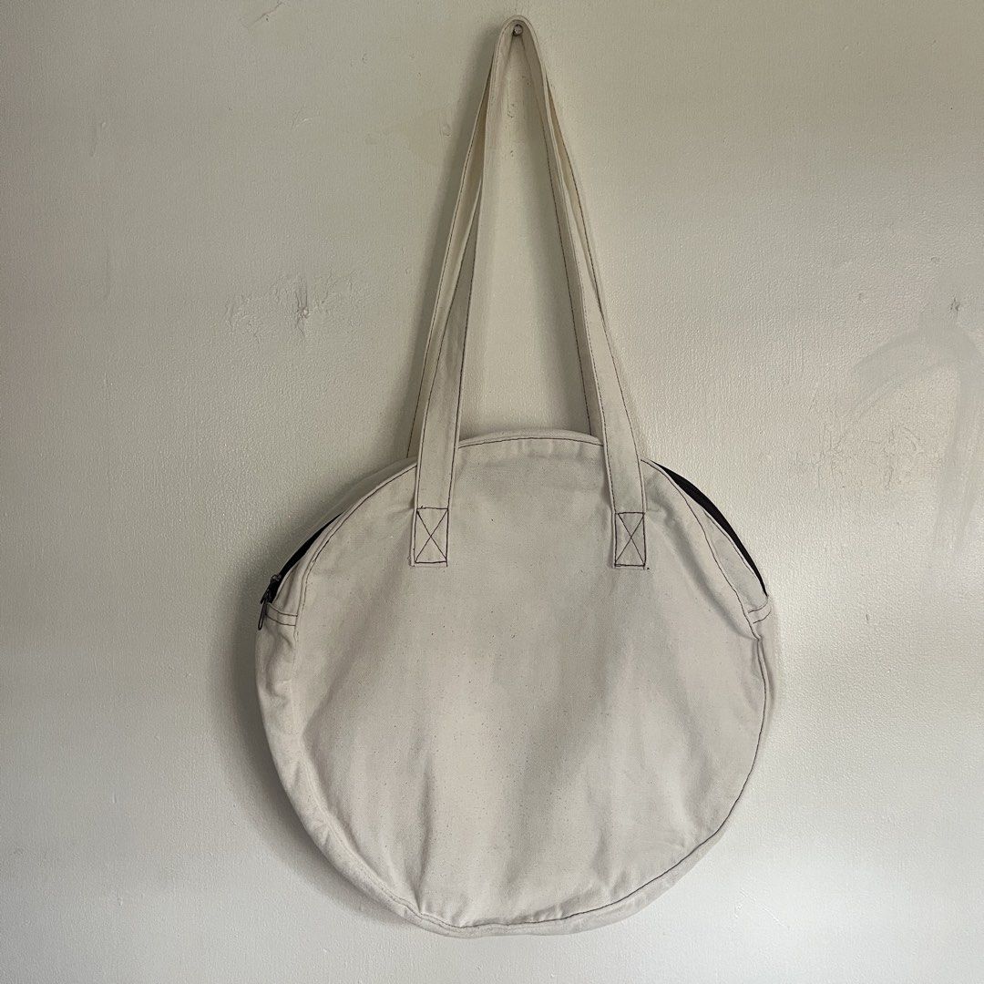 Lori Studio Canvas Round Tote Bag (Category: Tote Bags) located in Las Pinas. Submitted by solfits (Listing ID 1459327146, Image 2). Description: - Cream colored round tote bag by Lori Studio - Durable canvas material - Secure zippered closure - Convenient exterior pocket - 3 interior pockets for organization - Ideal for everyday use.