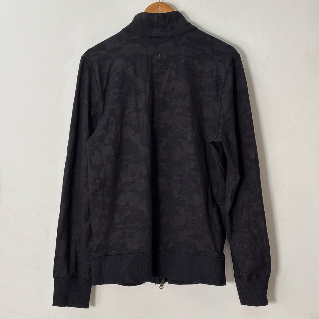 Lululemon Camo Track Jacket Double Zip Mens Size M (Category: Coats, Jackets and Outerwear) located in Malilipot. Submitted by brevsthrift (Listing ID 1459334400, Image 2). Description: - Lululemon black camouflage track jacket - Full zip front with stand-up collar - Zippered chest pocket (left side) - Ribbed cuffs and hem - Thumbholes on sleeves - Ideal for workouts or casual wear - No issue -W20.5 L26 Plus sf.