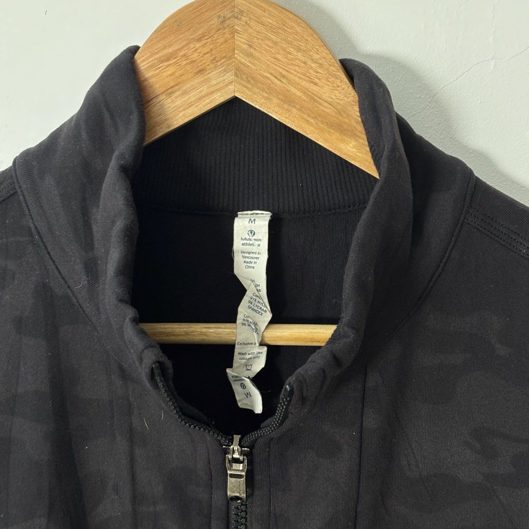 Lululemon Camo Track Jacket Double Zip Mens Size M (Category: Coats, Jackets and Outerwear) located in Malilipot. Submitted by brevsthrift (Listing ID 1459334400, Image 3). Description: - Lululemon black camouflage track jacket - Full zip front with stand-up collar - Zippered chest pocket (left side) - Ribbed cuffs and hem - Thumbholes on sleeves - Ideal for workouts or casual wear - No issue -W20.5 L26 Plus sf.