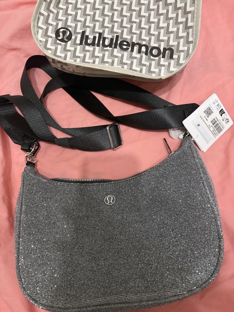 Lululemon Glitter Crossbody Bag - Silver (Category: Cross-body Bags) located in Quezon City. Submitted by eyjheyshop (Listing ID 1459382940, Image 1). Description: - Sparkly silver Lululemon crossbody bag - Main zippered compartment - Inner pocket - Adjustable strap - Comes with Lululemon dust bag - Ideal for everyday use or a night out.