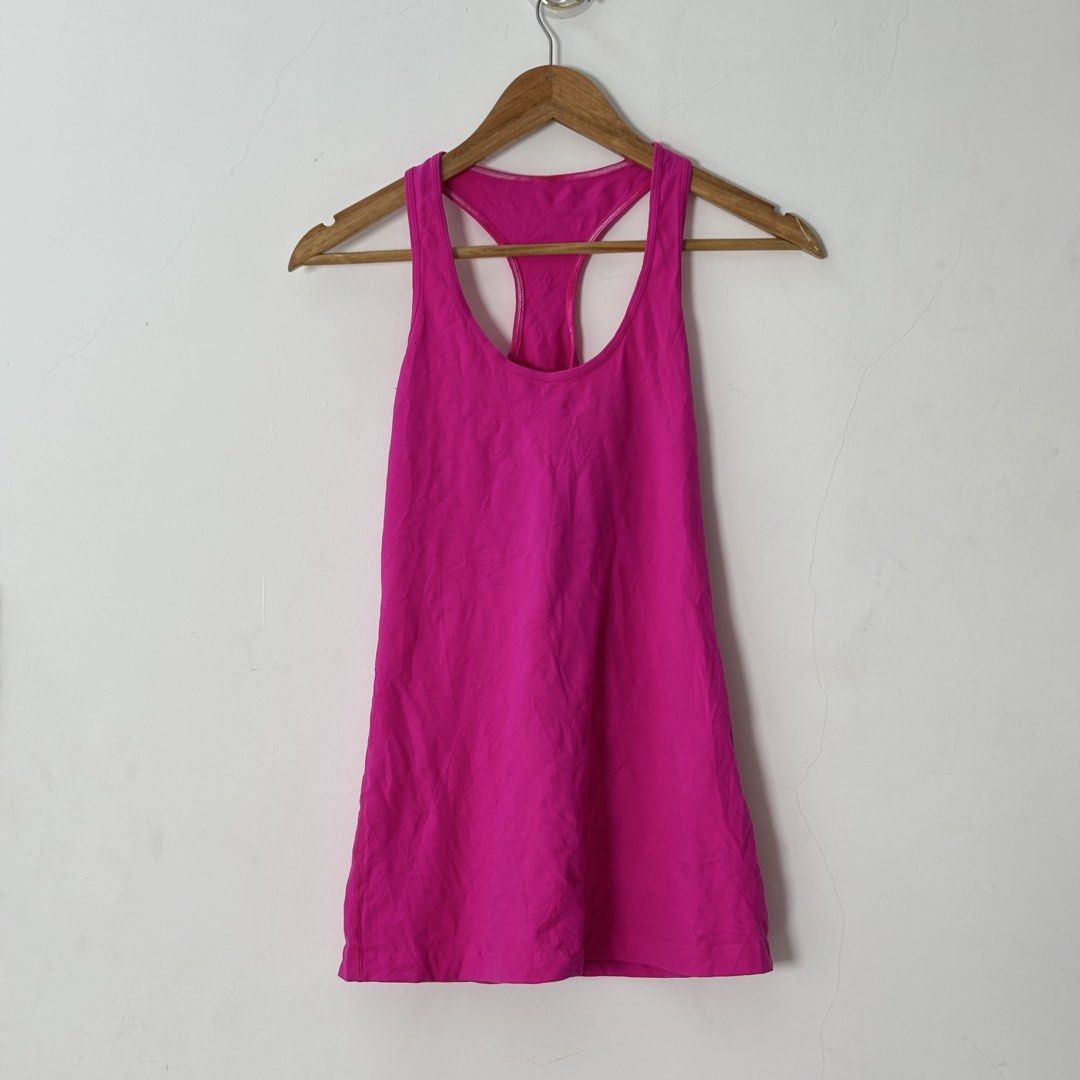 Lululemon Hot Pink Racerback Tank Top (Category: Sleeveless) located in Malilipot. Submitted by brevsthrift (Listing ID 1459336881, Image 1). Description: - Hot pink Lululemon tank top - Racerback style - Ideal for workouts or casual wear - Made with soft and breathable fabric - Versatile for layering or wearing alone - like new -W15 L26 Plus sf.