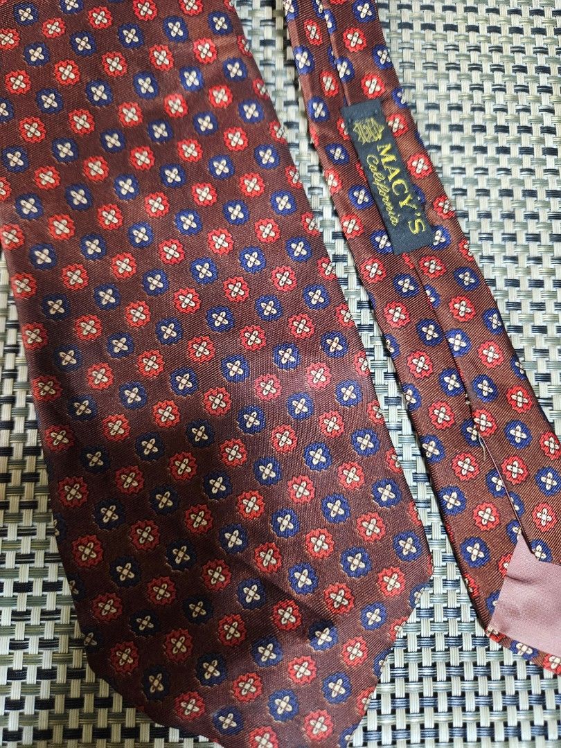 Macy's California Kipper Silk Tie - Red Blue Pattern (Category: Ties) located in Rizal. Submitted by cherry_garcia (Listing ID 1459382265, Image 3). Description: - Classic silk tie from Macy's California - Rich brown background with a repeating red and blue floral-like pattern - Small Kipper brand tag on the back - Ideal for formal events or business casual attire - Adds a stylish pop of color to your look.
